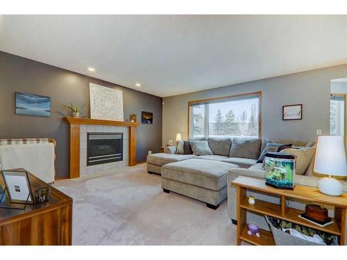 63 Woodpark Close Sw, Calgary, AB - Indoor Photo Showing Living Room With Fireplace