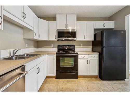 154 Saddlebrook Point Ne, Calgary, AB - Indoor Photo Showing Kitchen With Double Sink