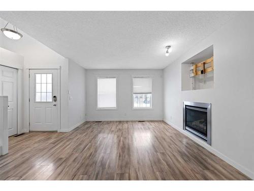 133 Covepark Crescent Ne, Calgary, AB - Indoor Photo Showing Living Room With Fireplace