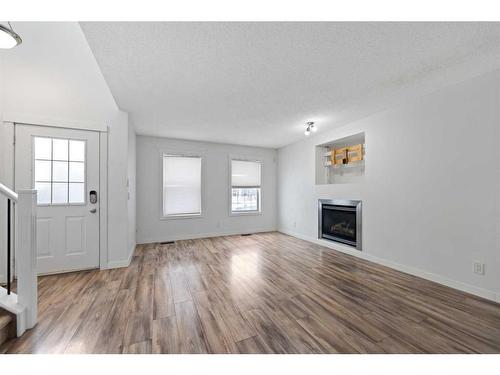 133 Covepark Crescent Ne, Calgary, AB - Indoor Photo Showing Living Room With Fireplace