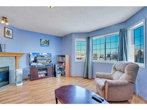 115 Coral Springs Circle Ne, Calgary, AB - Indoor Photo Showing Living Room With Fireplace