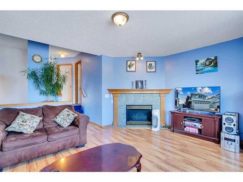 115 Coral Springs Circle Ne, Calgary, AB - Indoor Photo Showing Living Room With Fireplace