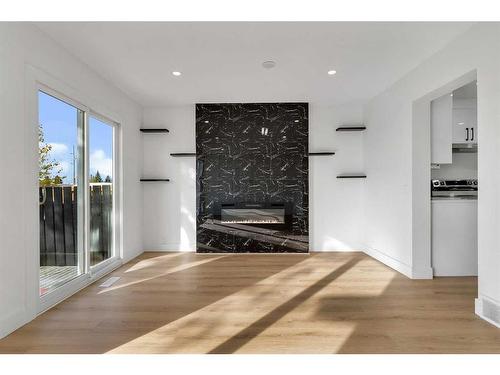 256 Abinger Crescent Ne, Calgary, AB - Indoor Photo Showing Living Room With Fireplace