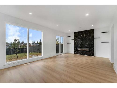 256 Abinger Crescent Ne, Calgary, AB - Indoor Photo Showing Living Room With Fireplace