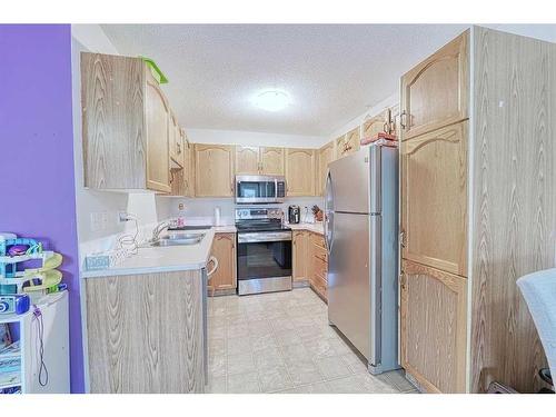 13 Mt Aberdeen Manor Se, Calgary, AB - Indoor Photo Showing Kitchen With Double Sink