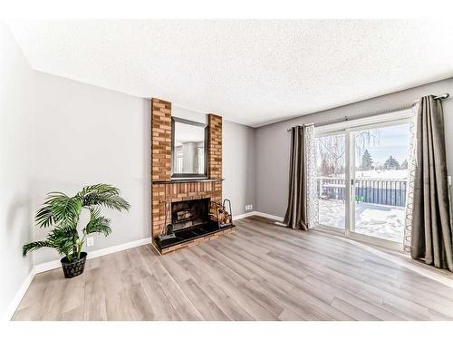 83 Ranchridge Way Nw, Calgary, AB - Indoor Photo Showing Living Room With Fireplace