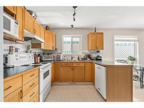 212 Tuscany Valley Way Nw, Calgary, AB - Indoor Photo Showing Kitchen With Double Sink