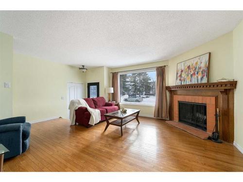 8 Oakvale Place Sw, Calgary, AB - Indoor Photo Showing Living Room With Fireplace