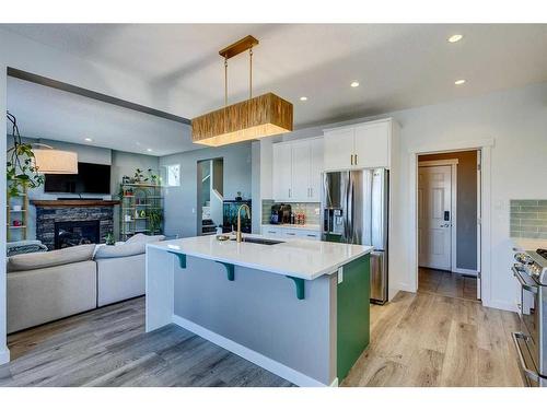 56 Elgin Meadows Link Se, Calgary, AB - Indoor Photo Showing Kitchen With Fireplace With Stainless Steel Kitchen With Upgraded Kitchen