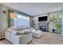 56 Elgin Meadows Link Se, Calgary, AB  - Indoor Photo Showing Living Room With Fireplace 