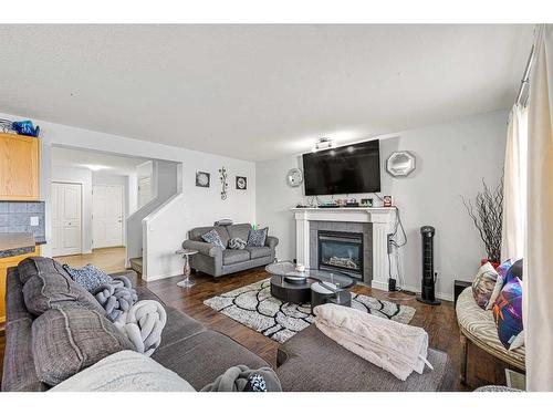 253 Saddlecrest Way Ne, Calgary, AB - Indoor Photo Showing Living Room With Fireplace