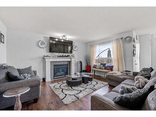 253 Saddlecrest Way Ne, Calgary, AB - Indoor Photo Showing Living Room With Fireplace