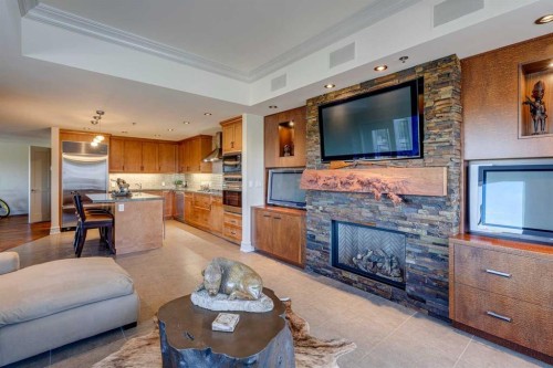 702-600 Princeton Way Sw, Calgary, AB - Indoor Photo Showing Living Room With Fireplace