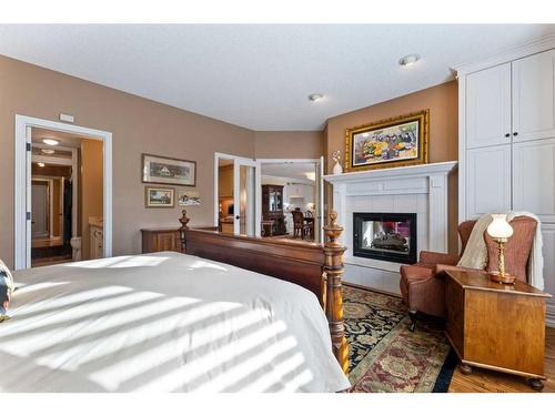 55 Prominence Point Sw, Calgary, AB - Indoor Photo Showing Bedroom With Fireplace