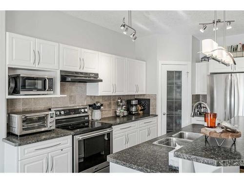 103 Bridle Estates Mews Sw, Calgary, AB - Indoor Photo Showing Kitchen With Stainless Steel Kitchen With Double Sink With Upgraded Kitchen