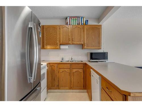 103 Country Hills Villas Nw, Calgary, AB - Indoor Photo Showing Kitchen With Double Sink