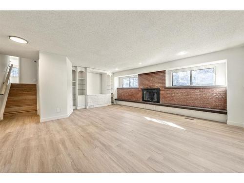 588 Silvergrove Drive Nw, Calgary, AB - Indoor Photo Showing Other Room With Fireplace