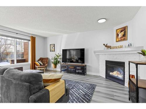 130 Chapalina Close Se, Calgary, AB - Indoor Photo Showing Living Room With Fireplace