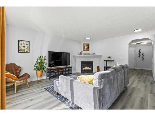 130 Chapalina Close Se, Calgary, AB - Indoor Photo Showing Living Room With Fireplace