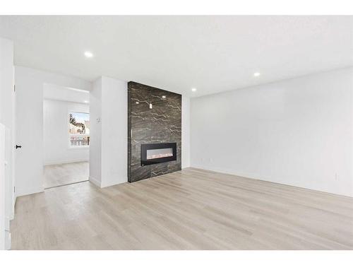 16 Erin Circle Se, Calgary, AB - Indoor Photo Showing Other Room With Fireplace