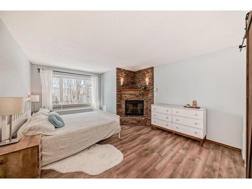 95 Tuscany Hills Park Nw, Calgary, AB - Indoor Photo Showing Bedroom With Fireplace