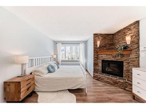 95 Tuscany Hills Park Nw, Calgary, AB - Indoor Photo Showing Bedroom With Fireplace