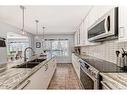 95 Tuscany Hills Park Nw, Calgary, AB  - Indoor Photo Showing Kitchen With Double Sink With Upgraded Kitchen 