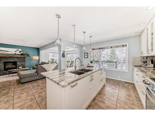 95 Tuscany Hills Park Nw, Calgary, AB - Indoor Photo Showing Kitchen With Fireplace With Double Sink With Upgraded Kitchen