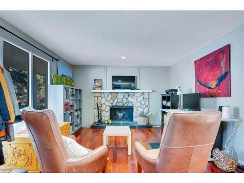 1031 Cannock Place Sw, Calgary, AB - Indoor Photo Showing Living Room With Fireplace