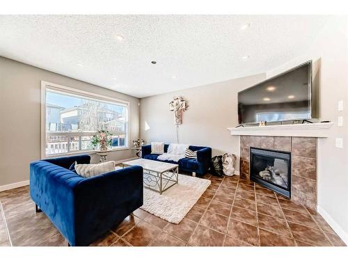 153 Chapalina Heights Se, Calgary, AB - Indoor Photo Showing Living Room With Fireplace