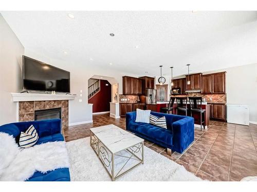 153 Chapalina Heights Se, Calgary, AB - Indoor Photo Showing Living Room With Fireplace