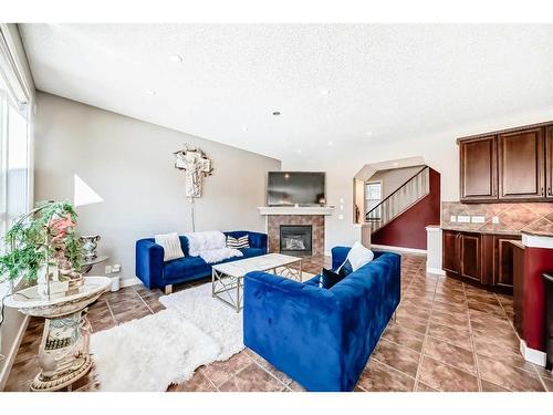 153 Chapalina Heights Se, Calgary, AB - Indoor Photo Showing Living Room With Fireplace