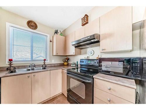 62 Eversyde Common Sw, Calgary, AB - Indoor Photo Showing Kitchen With Double Sink