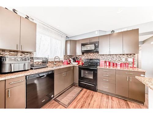 127 Abalone Way Ne, Calgary, AB - Indoor Photo Showing Kitchen With Double Sink