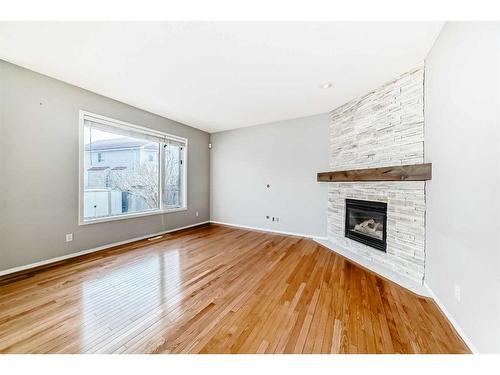 18 Coral Reef Crescent Ne, Calgary, AB - Indoor Photo Showing Other Room With Fireplace