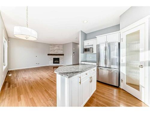 18 Coral Reef Crescent Ne, Calgary, AB - Indoor Photo Showing Kitchen With Fireplace