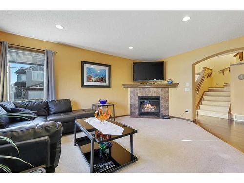 304 New Brighton Place Se, Calgary, AB - Indoor Photo Showing Living Room With Fireplace