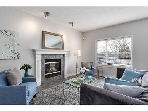 174 Cranfield Green Se, Calgary, AB - Indoor Photo Showing Living Room With Fireplace