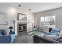 174 Cranfield Green Se, Calgary, AB  - Indoor Photo Showing Living Room With Fireplace 