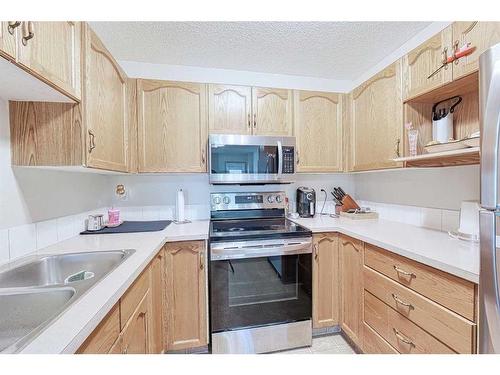 13 Mt Aberdeen Manor Se, Calgary, AB - Indoor Photo Showing Kitchen With Double Sink