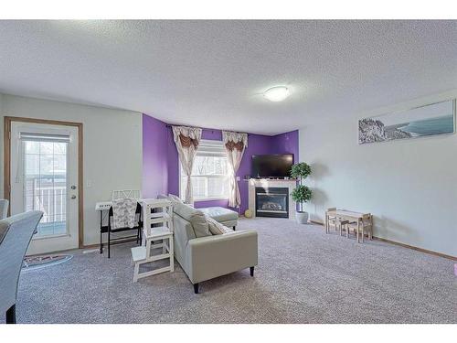 13 Mt Aberdeen Manor Se, Calgary, AB - Indoor Photo Showing Other Room With Fireplace