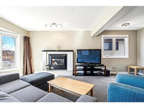 112 Beaconsfield Way Nw, Calgary, AB - Indoor Photo Showing Living Room With Fireplace