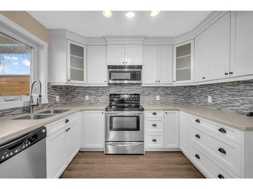 64 Hidden Way Nw, Calgary, AB - Indoor Photo Showing Kitchen With Stainless Steel Kitchen With Double Sink With Upgraded Kitchen