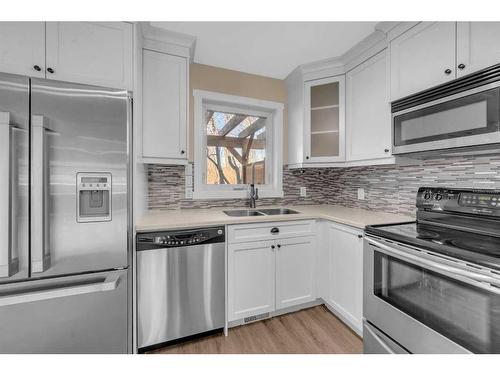 64 Hidden Way Nw, Calgary, AB - Indoor Photo Showing Kitchen With Stainless Steel Kitchen With Double Sink With Upgraded Kitchen