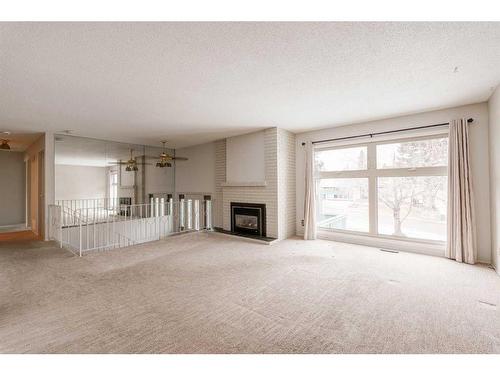 7 Lake Sundance Place Se, Calgary, AB - Indoor Photo Showing Living Room With Fireplace