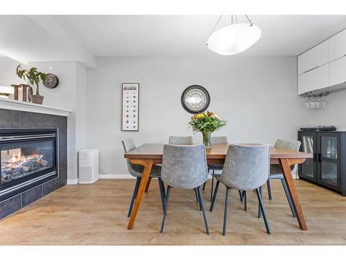 149 New Brighton Green Se, Calgary, AB - Indoor Photo Showing Dining Room With Fireplace