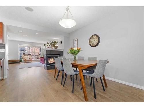 149 New Brighton Green Se, Calgary, AB - Indoor Photo Showing Dining Room With Fireplace