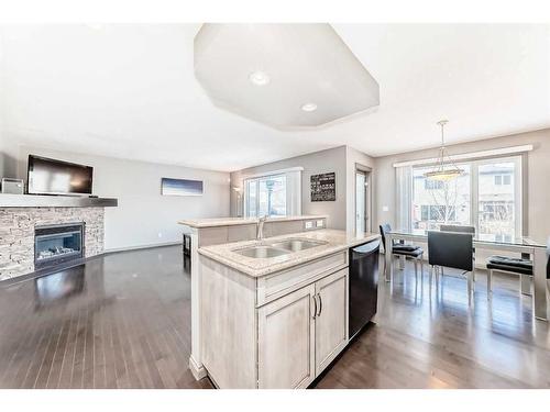 971 Auburn Bay Boulevard Se, Calgary, AB - Indoor Photo Showing Kitchen With Fireplace With Double Sink