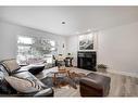 435 Queensland Road Se, Calgary, AB  - Indoor Photo Showing Living Room With Fireplace 