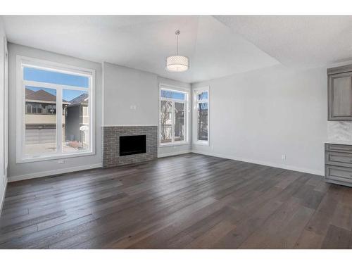 338 Shawnee Boulevard Sw, Calgary, AB - Indoor Photo Showing Living Room With Fireplace